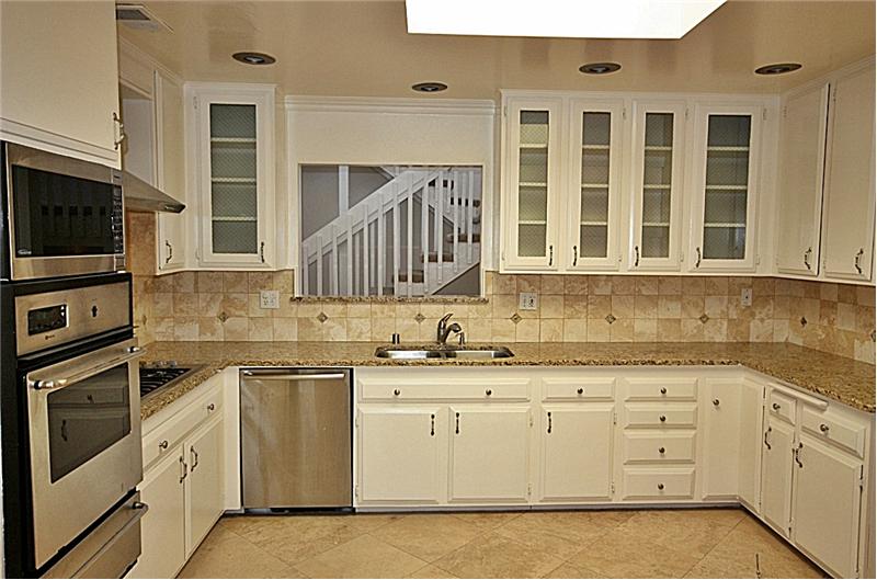 Kitchen with granite counters, travertine floors and stainless steel appliances