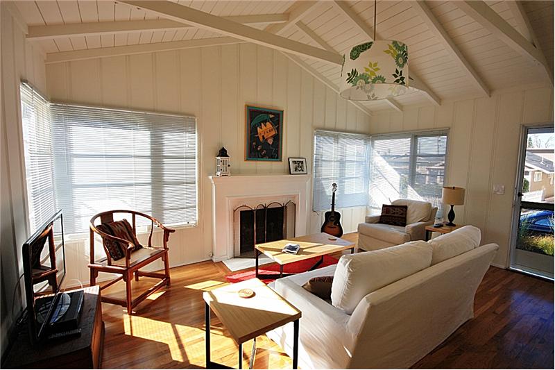 Light and bright living room with high open beam ceilings