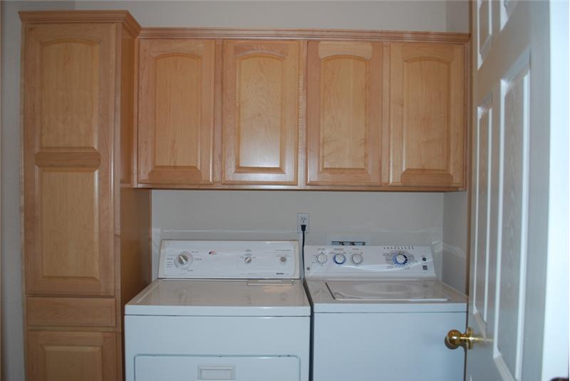 Large Indoor Laundry Room with Storage Cabinets