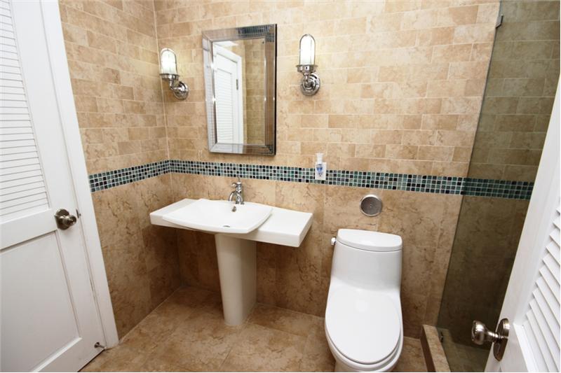 Mosaic inserts style the bathrooms with contemporary glamour
