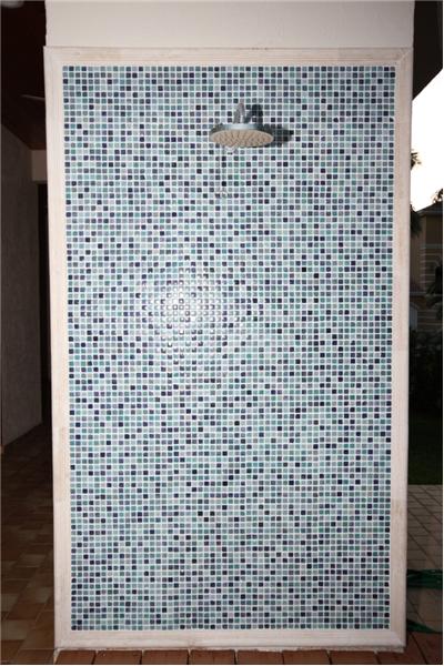 Hand applied mosaic blue tile outdoor shower for cooling off on those sunny Florida days.