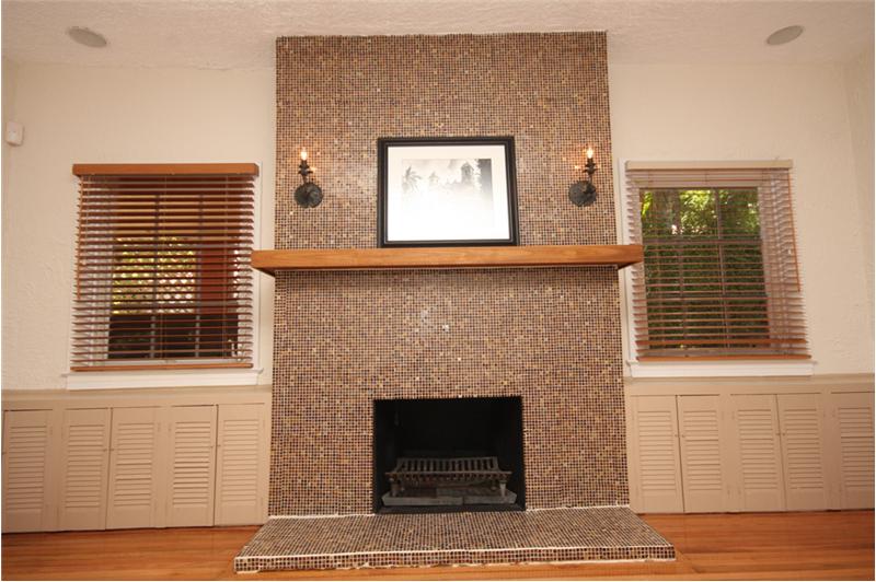 The fireplace provides a stunning focal point with storage on either side