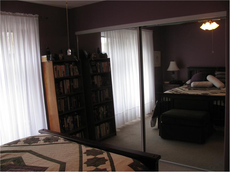 Master bedroom with mirrored closet