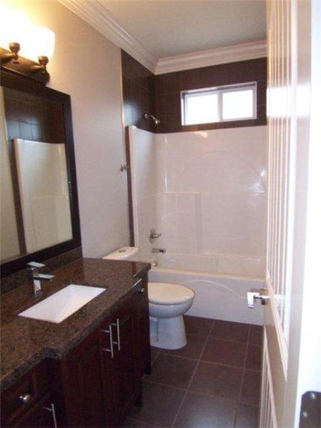 Full bathroom with granite counter and title floor